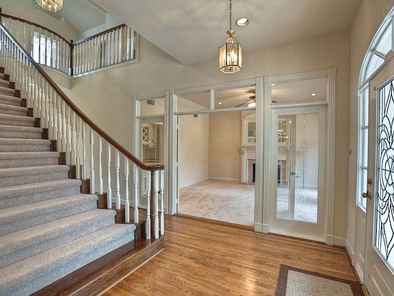 Expansive and dramatic stairway overlook entry and study.