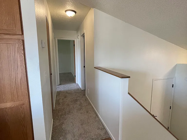 View from kitchen down hallway on upper level to master bedroom and bedroom #2