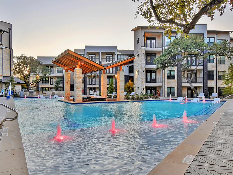 The resort-style pool lit up at night.
