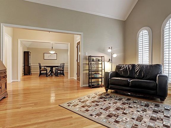 Formal living room space. Custom plantation shutters and vaulted ceilings.