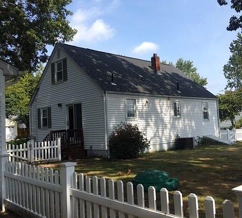 Rear of house with fenced in Backyard