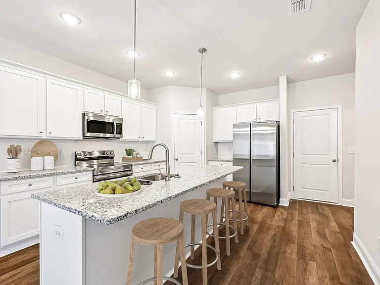 A view of the spacious kitchen and stainless steel appliances