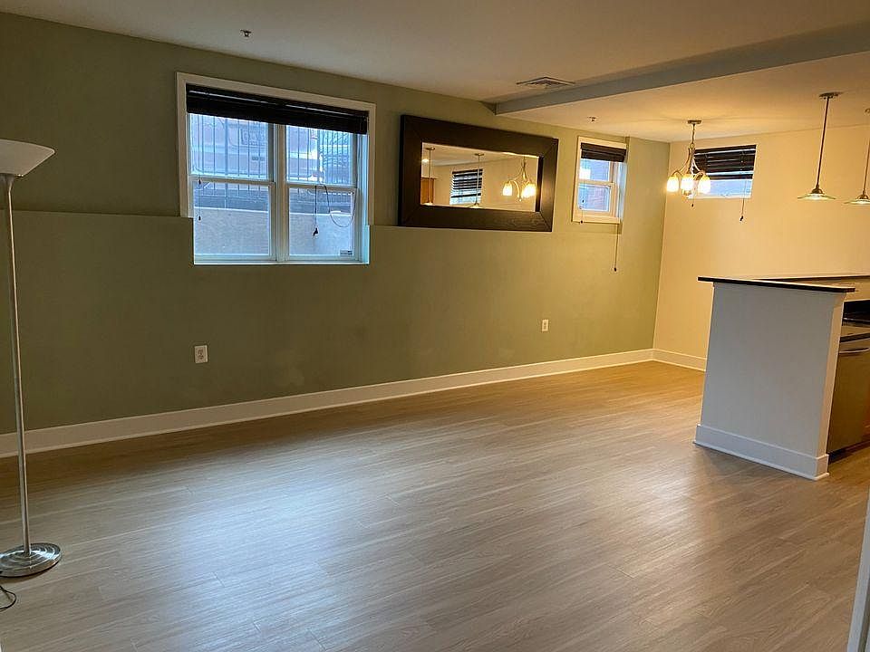 Living room and kitchen open up to a space that can be used as a dining room or a home office