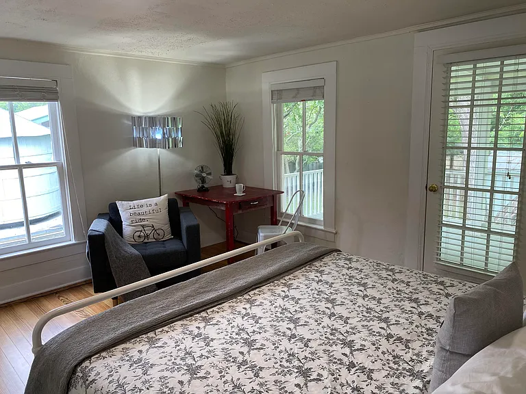 Upstairs west bedroom leads to large balcony with rocking chairs.