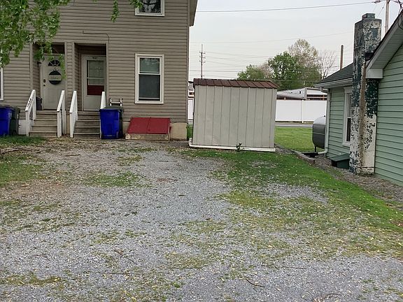 Rear of duplex with side view of 8X10 storage shed plus parking area