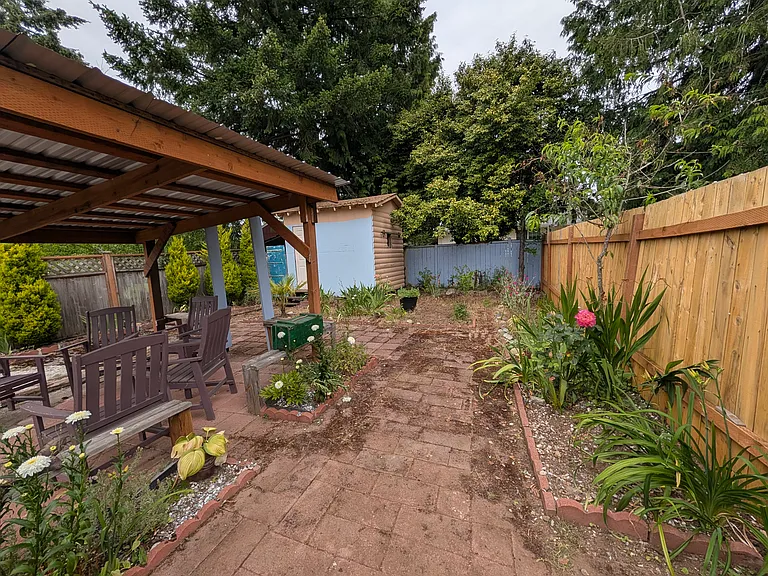 There is a fence dividing unit A from B along with plenty of gardening space with nice flowers established
