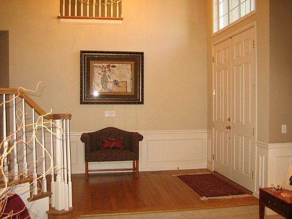 Double door, inviting grand entry opens to show case an elegant curved staircase, formal living & di