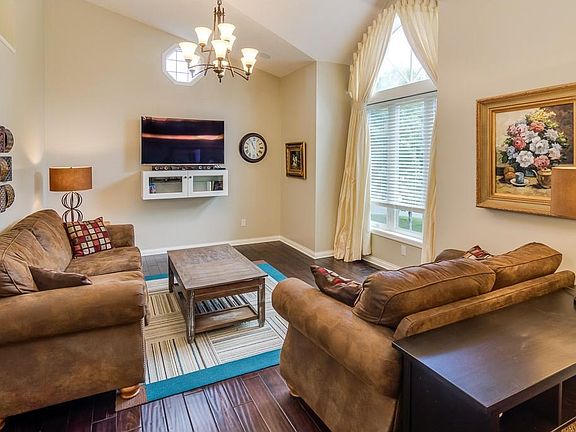 Main level living room with media cabinet and new acacia hand scraped hardwood floor.