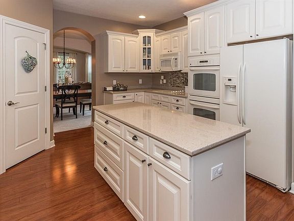 Updated creamy white gourmet kitchen w large island. All appliances stay!