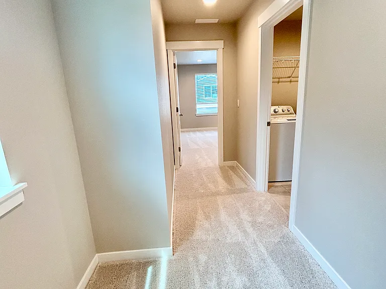 Hallway to private primary suite