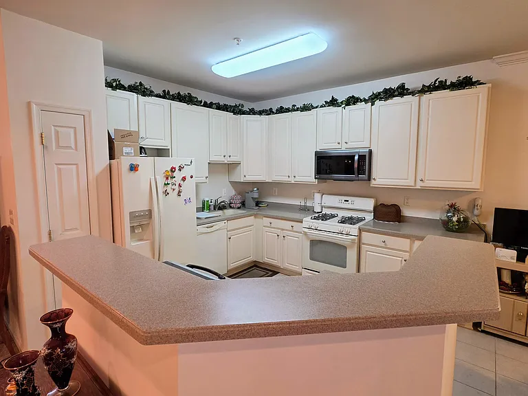 An open-concept kitchen layout boasting an expansive breakfast bar that keeps the chef connected to the guests.