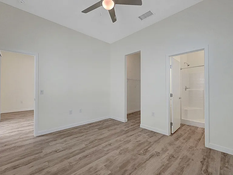 Step into comfort in this bright and airy bedroom, complete with modern amenities.