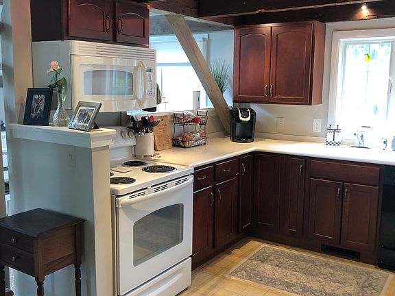 Kitchen: Full-size stove, microwave, pass-through to dining room. Open beams, recessed lighting.