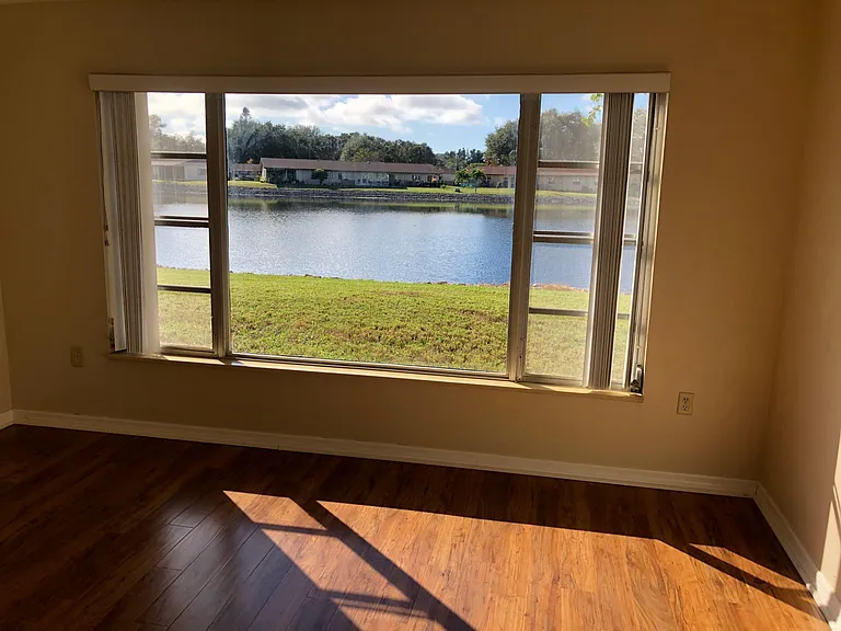 LAKE VIEWS FROM EXCEPTIONALLY LARGE PICTURE WINDOW IN OWNERS BEDROOM
