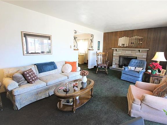 Large 20x13 Living Room featuring Log Burning Stone Fireplace. Lots of Natural Light flows through nicely
