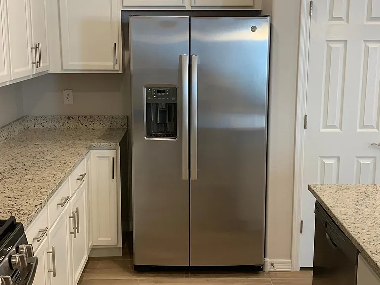 Large side by side stainless steel refrigerator with ice and water dispenser