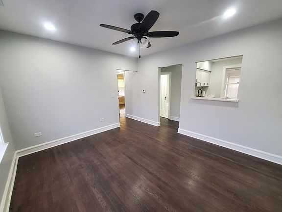 Living Room 2nd view. Recessed lighting, quartz bar top in partition wall