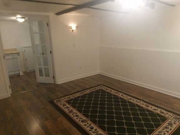 Living Room view next to double French doors leading into Large Eat-in Kitchen and walk-in Pantry