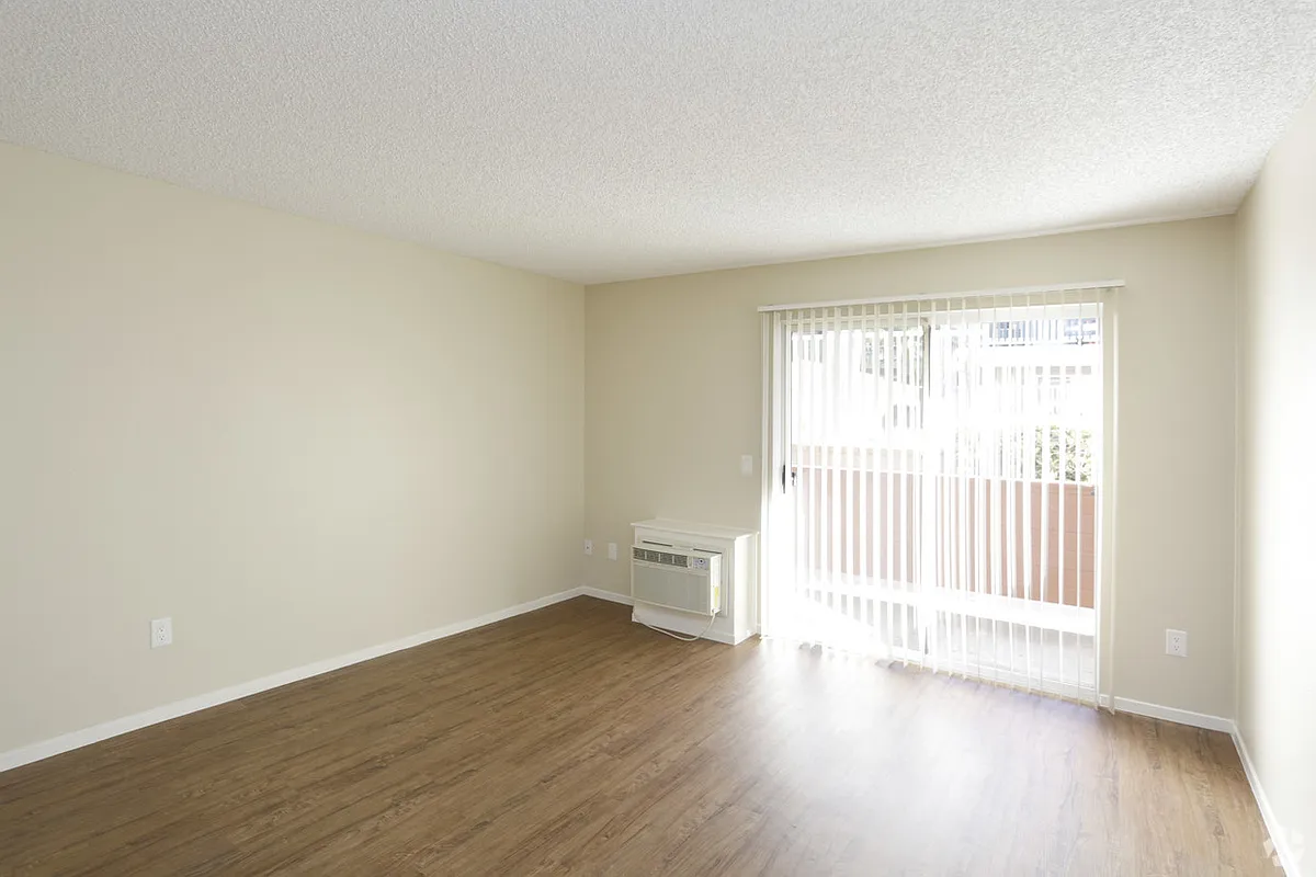 Living room areas with sliding glass door - Benchmark Apartments