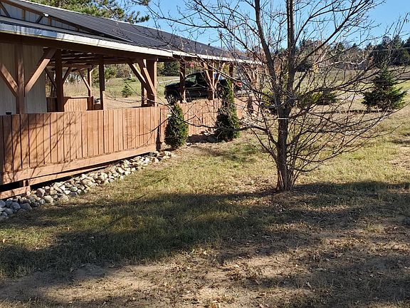 Covered front deck, with fenced in porch, to main front door entrance.