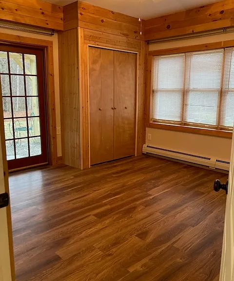 Front bedroom with an exit to a covered sitting area, facing the yard