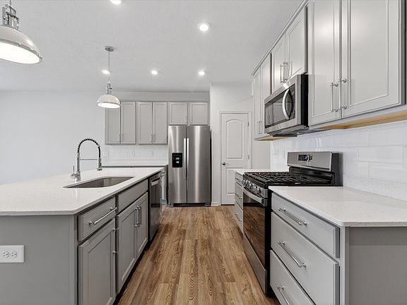 Gourmet kitchen with tons of natural light, HUGE island and tons of cabinetry