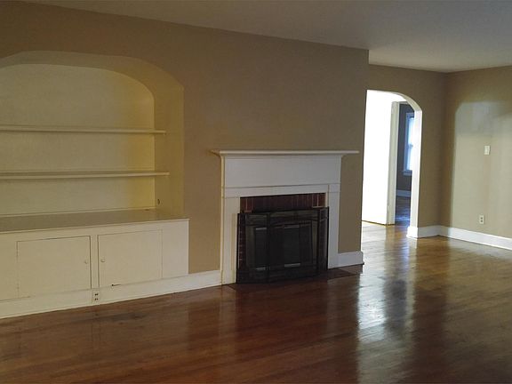 Large living room with wood burning fireplace and build-in bookcase.