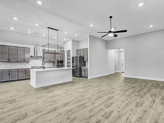 Open-concept layout with the spacious family room connected to the designer kitchen.
