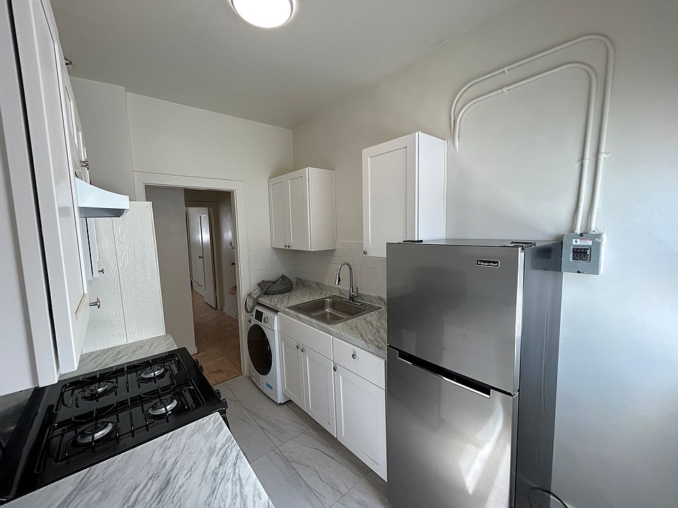 Renovated Kitchen with new flooring, cabinets, gas stove/oven, washer/dryer, water heater, and refrigerator.