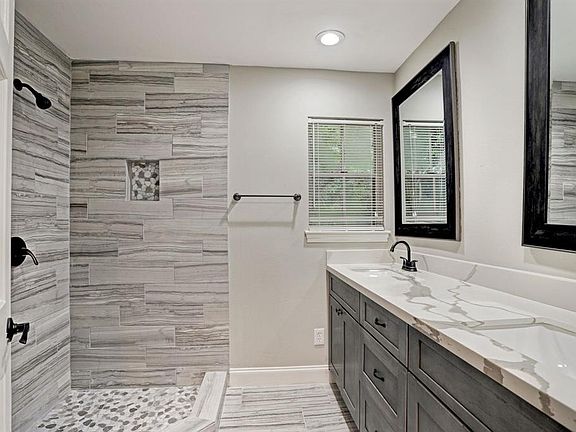 The Master Bathroom with double sinks is tranquil with beautiful tiling throughout