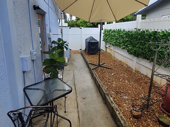 The apartment's fenced patio and front door entrance.