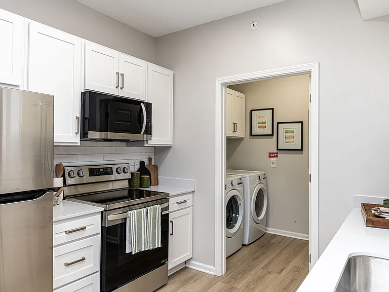Kitchen & laundry room with hardwood-style flooring