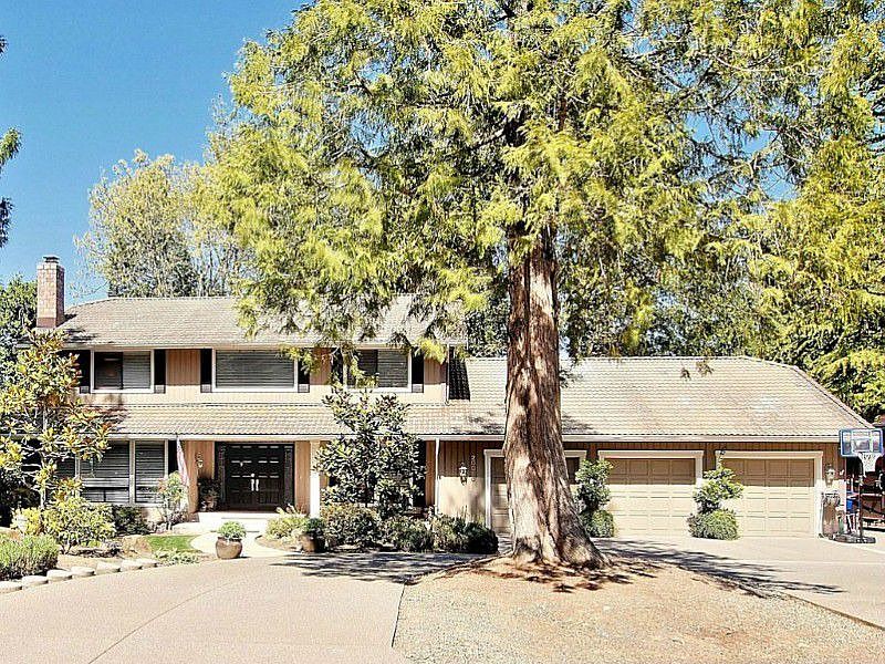 Gorgeous setting on a large flat corner lot. 3 car garage and tile roof.