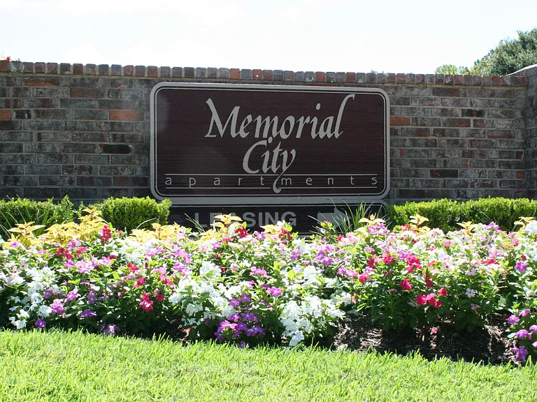 Brick monument sign with vibrant floral landscaping