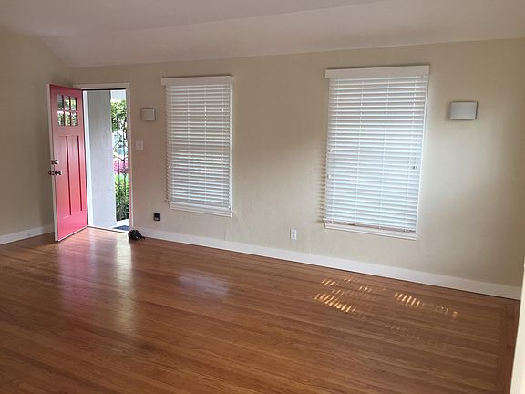The front door opens into a large, airy living room.
