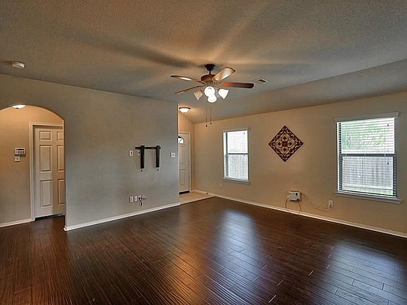 Alternate view of the living room looking towards the hallway leading to the secondary bedrooms.