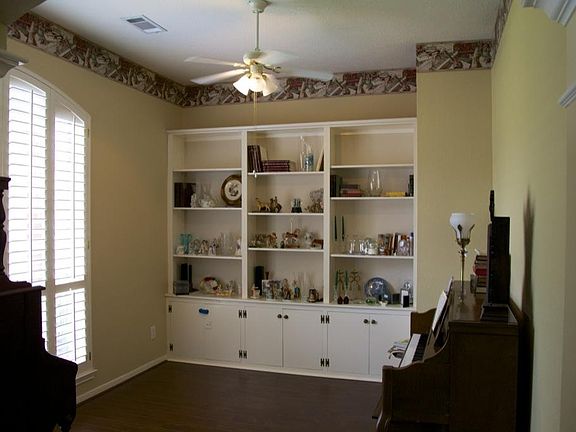 Formal living or home office. Custom built in cabinets.