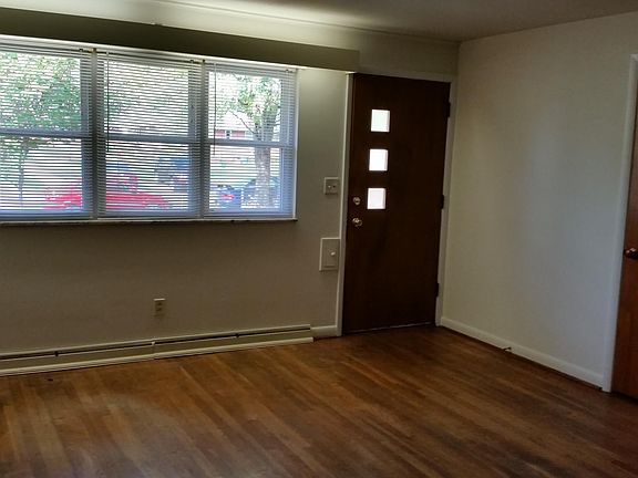 Living Room w/ Hardwood Floors & Coat Closet