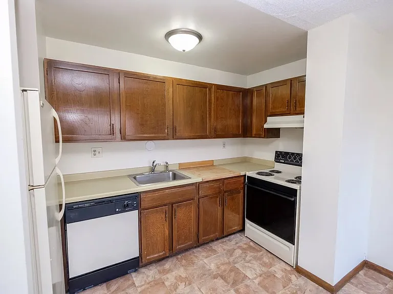 Welcome to Central Lakes of Uptown, where modern living meets comfort. This well-equipped kitchen features stunning wood cabinetry and ample countertop space, perfect for culinary enthusiasts. Schedule a tour today and envision your new home!