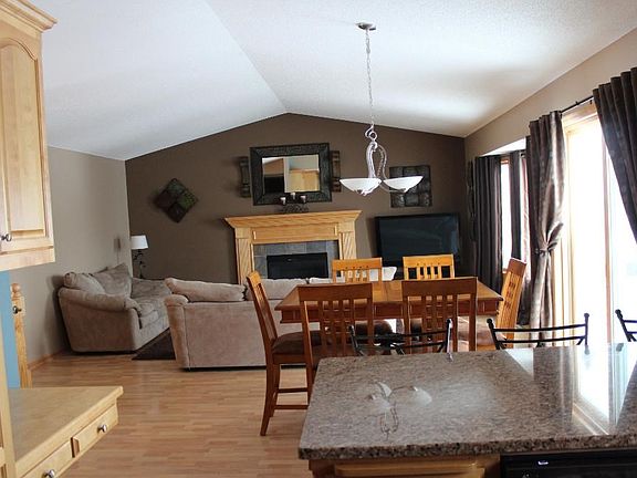 View from living room towards kitchen & hall to three bedrooms & bathroom.