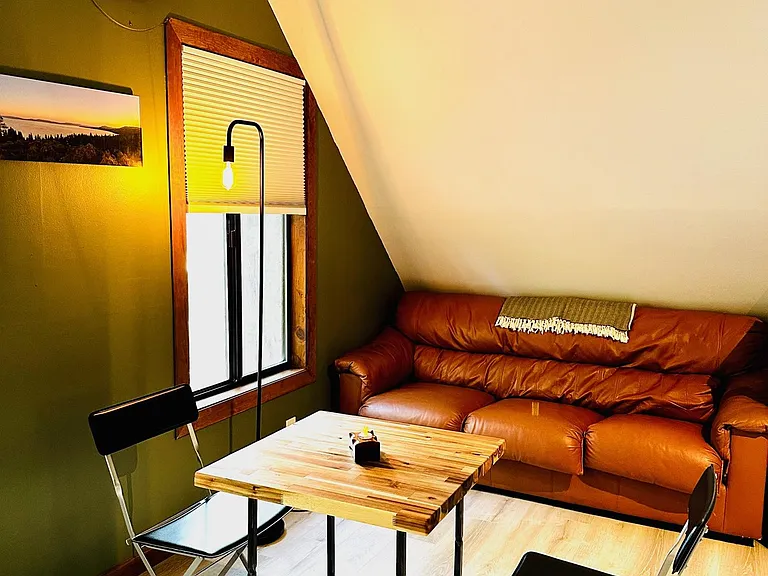 Leather couch and handcrafted steel base, butcher block dining table