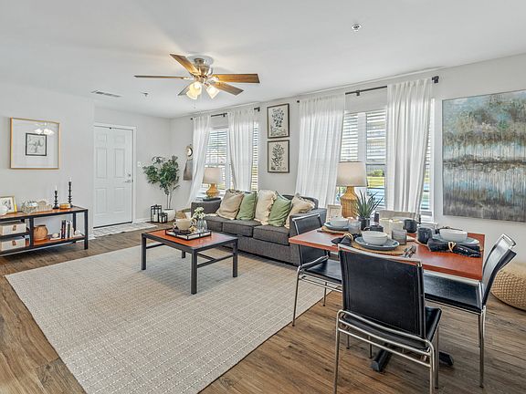 Living Room with Ceiling Fan and Track Lighting Fixture