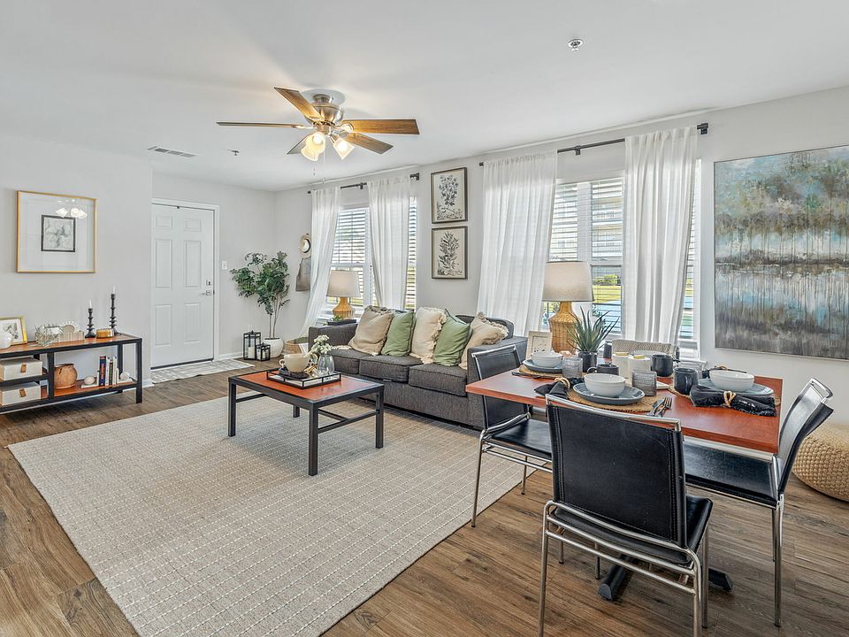 Living Room with Ceiling Fan and Track Lighting Fixture
