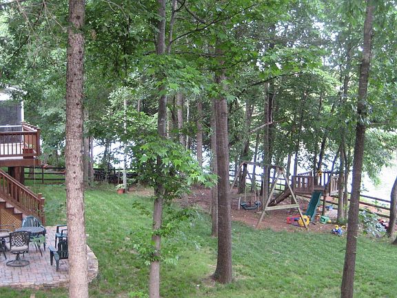 large fenced backyard, on the lake, stone patio, deck, screened porch