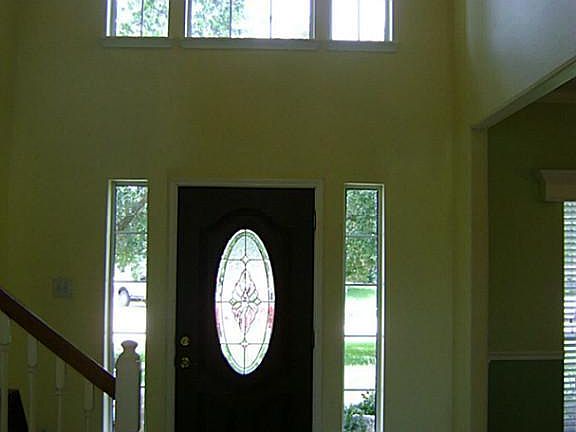 Grand Entry With High Ceilings & Tile Floor