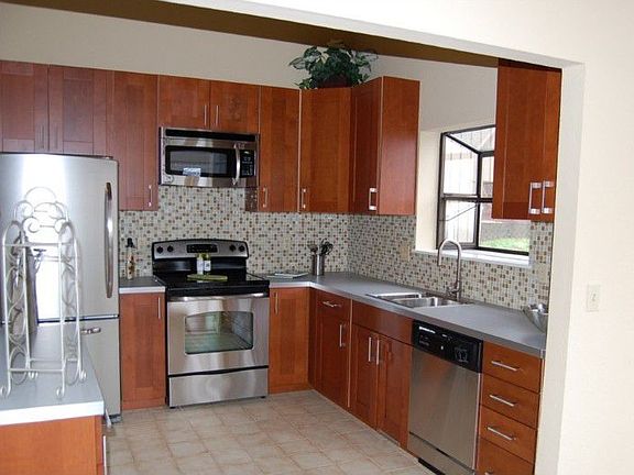 Sunny Kitchen with brand new cabinets, stainless steel appliances and a garden window.