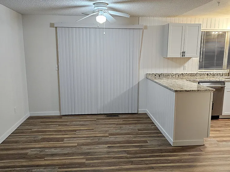 Dining area with ceiling fan. Large slider exits to backyard.
