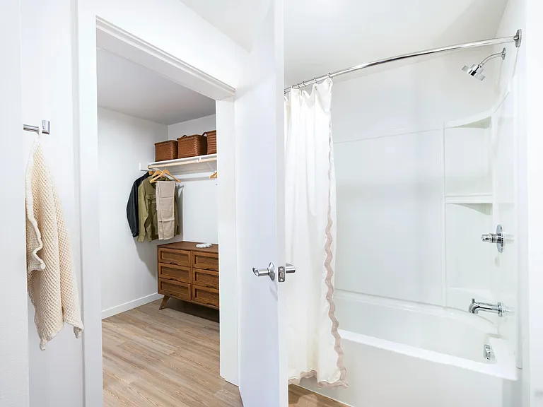 Streamline your routine with a dual-access bathroom featuring a spacious pass-through closet.