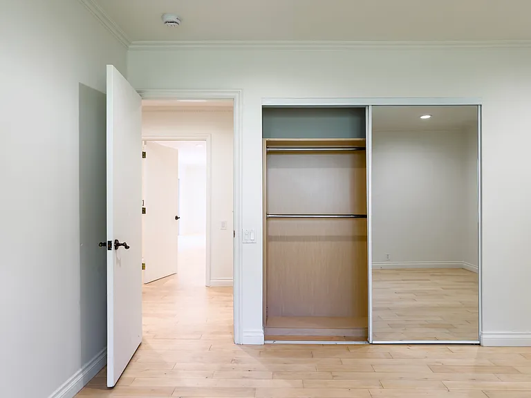 Mirrored sliding closet doors offer generous storage in this Beverly Hills luxury rental hallway at 1094 Garden Lane, a well-appointed 90210 home for rent.