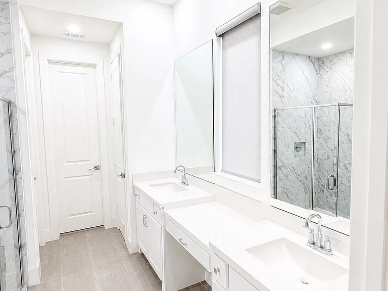 Master bathroom another view with two sinks and cabinets